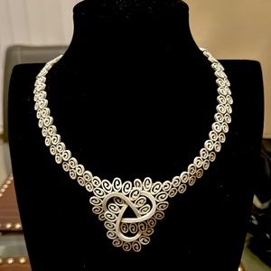 Woman’s white enamel Celtic necklace by Trifari. Lovely and Brilliant